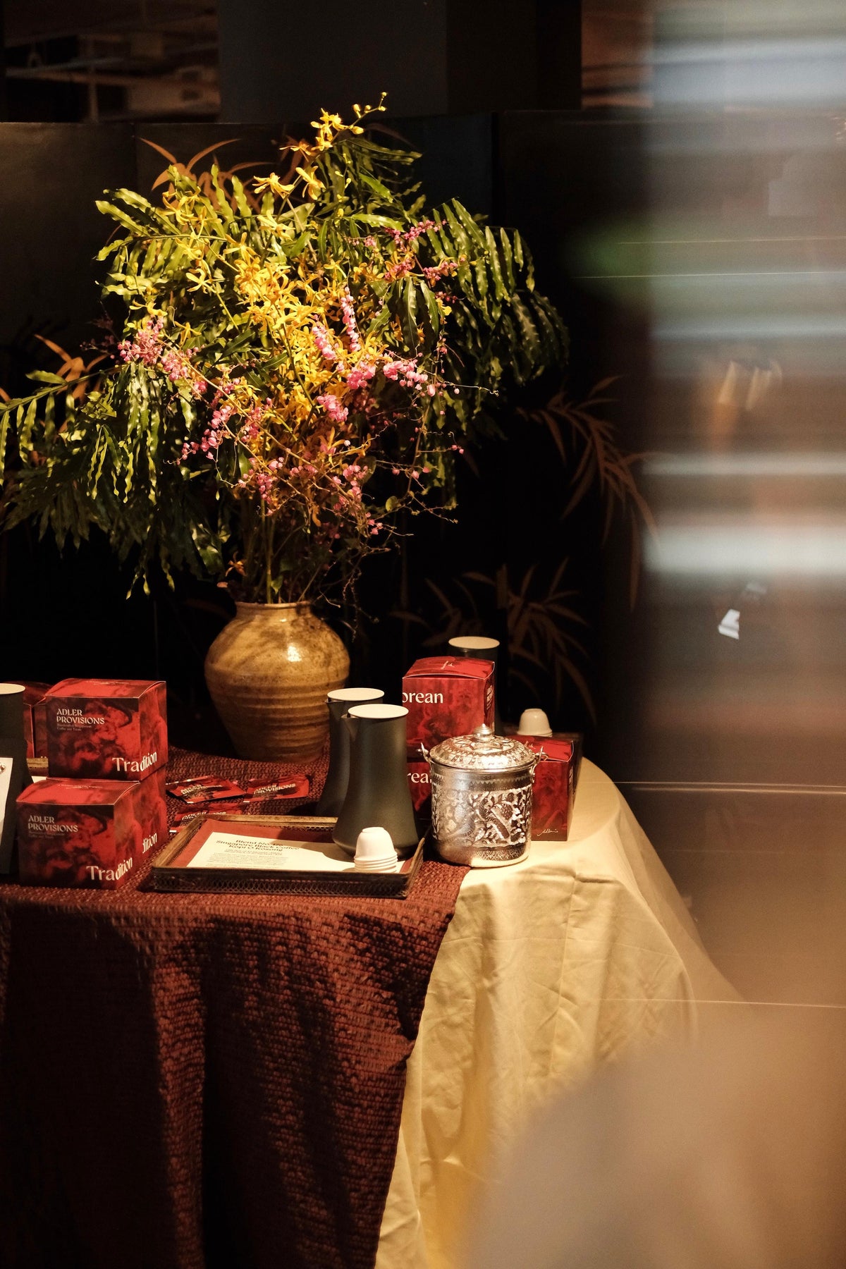 Adler Provisions kopi and gifts arranged on a table with flowers